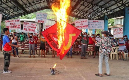 <p><strong>PERSONA NON GRATA</strong>. Residents of an undisclosed barangay in the Visayas burn flags of the Communist Party of the Philippines-New People's Army (CPP-NPA) to express their indignation. Visayas Command (Viscom) commander, Lt. Gen. Robert Dauz on Saturday (Jan. 29, 2022) said due to the dwindling support from the community, the CPP-NPA is getting irrelevant in the region. <em>(Contributed photo)</em></p>