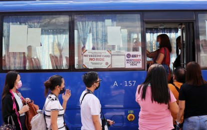 <p><strong>CASHLESS PAYMENT.</strong> Passengers queue to tap their 'Beep' card to pay their fares before taking a seat on a modern jeepney along Commonwealth Avenue, Philcoa in Quezon City on Jan. 31, 2022. The Department of Transportation on Tuesday (Oct. 11) announced its intention to expand the existing automated fare collection system (AFCS) in modern jeepneys, buses, and rail lines to enable other methods of cashless payments such us using bank cards and mobile devices. <em>(PNA photo by Joey O. Razon)</em></p>