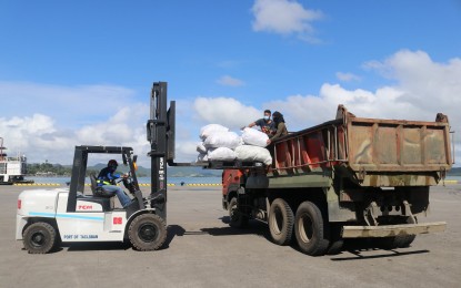 <p><strong>AID FOR TYPHOON VICTIMS</strong>. Food items for Typhoon Odette victims are loaded into a truck at the Tacloban port in this Feb. 3, 2022 photo. The Department of Social Welfare and Development has received thousands of food packs from big firms in the country for victims of Typhoon Odette in Leyte and Southern Leyte provinces. <em>(Photo courtesy of DSWD)</em></p>