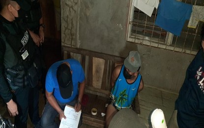 <p><strong>BUSTED.</strong> Agents of the Philippine Drug Enforcement Agency in Davao Region (PDEA-11) seize the shabu items from suspected drug peddler Anthony Louie Tura (seated, blue sando), Davao Oriental’s second most drug personality, following his arrest on Wednesday (Feb. 2, 2022) in a buy-bust at his house in Barangay Central, Mati City, Davao Oriental. Recovered from the suspect was more than PHP15,000 worth of shabu. <em>(Photo courtesy of PDEA-11)</em></p>