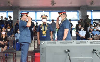 <p><strong>TURNOVER</strong>. National Capital Region Police Office (NCRPO) chief Maj. Gen. Vicente D. Danao Jr (center) leads the formal turnover of command responsibility of Quezon City Police District at QCPD Grandstand, Karingal, Sikatuna Village, Quezon City on Saturday (Feb. 6, 2022). Brig. Gen. Remus Balingasa Medina (right) replaced Brig. Gen. Antonio C. Yarra (left) as commander of QCPD. <em>(Contributed photo)</em></p>