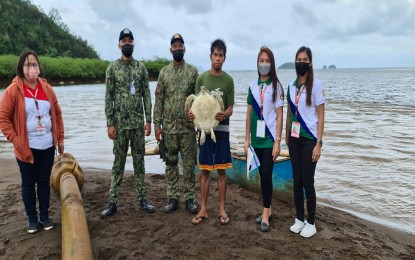<p><strong>RESCUED TURTLE.</strong> Personnel from the Municipal Environment and Natural Resources Office of Claver town in Surigao del Norte (MENRO-Claver) and the Philippine Maritime Police facilitate the release of a rescued green sea turtle in Hayanggabon, Surigao del Norte on Wednesday (Feb. 9, 2022). The MENRO-Claver urged residents to be vigilant in the protection and preservation of marine species in the area. <em>(Photo courtesy of MENRO - Claver)</em></p>