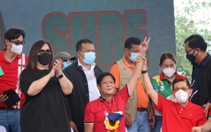 <p><strong>ENDORSEMENT</strong>. Former Senate President Juan Ponce Enrile (seated, right) raises the hand of Senator Ferdinand “Bongbong” Marcos Jr. to signify his endorsement of the latter's candidacy for president, amid cheers from Cagayano leaders and supporters on Tuesday (Feb. 14, 2022). With them is Enrile's daughter Katrina (in black dress). <em>(PNA photo by Villamor Visaya Jr.)</em></p>