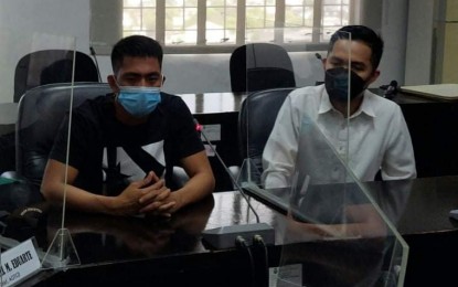 <p><strong>NOT ME.</strong> Ruel “Bong” Ricafort (left), accused of posting on social media an alleged assassination plan on presidential candidate Ferdinand Marcos Jr., surrenders to the National Bureau of Investigation on Feb. 9, 2022. He denied the allegation and has agreed to undergo a lie-detector test. <em>(Photo courtesy of NBI)</em></p>
