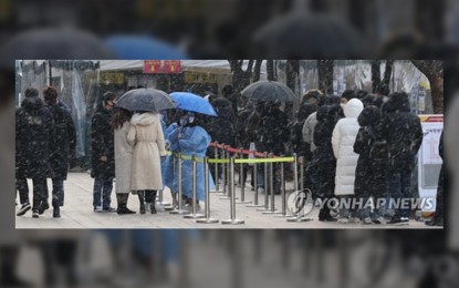<p><strong>SURGE.</strong> People wait in line to receive tests at a Covid-19 testing station in Seoul on Feb. 15, 2022. South Korea’s daily cases hit grim milestone of 90,443 amid Omicron woes. (Yonhap)</p>