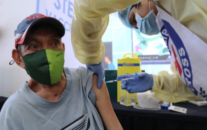<p><strong>STRONGER IMMUNITY.</strong> An elderly man gets his first booster shot against Covid-19 at a mall in Marikina City on Feb. 17, 2022. Senior citizens, frontline medical workers, and immunocompromised adults have been allowed to get the second booster dose. <em>(PNA photo by Joey O. Razon)</em></p>