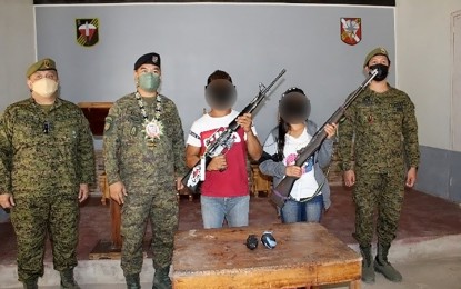 <p><strong>CHANCE WITH NEW LIFE.</strong> Two New People’s Army rebels operating in South Cotabato pose with their rifles with officials of the military following their surrender in Banga, South Cotabato on Feb. 12, 2022. The two surrenderers are undergoing custodial debriefing and are set for enrollment to the Enhanced Comprehensive Local Integration Program for livelihood and financial assistance. <em>(Photo courtesy of 6ID)</em></p>