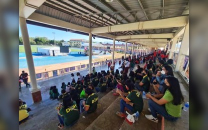 <p><strong>NOT DOH EMPLOYEES.</strong> Some people are seen wearing a green shirt which bears the Department of Health logo at a UniTeam campaign rally in Ilocos Sur on Thursday (Feb. 17, 2022). The department said the persons identified in the photo are not employees of the agency. <em>(Photo courtesy of DOH)</em></p>