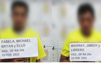 <p><strong>NABBED EXTORTIONISTS.</strong> Two suspects who identified themselves as members of the New People’s Army are arrested by the City Mobile Force Company, Cagayan de Oro City Police Office on Monday, Feb. 21, 2022. The police said they are still checking the veracity of the suspects' claim that they are part of the communist rebel group. <em>(Photo courtesy of CMFC-COCPO)</em></p>