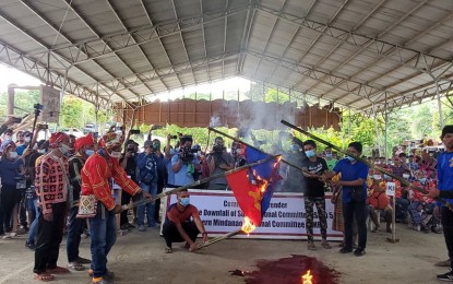 <p><strong>BURNING OF RED FLAGS.</strong> Former rebels and front members of the New People's Army (NPA) lead the burning of the Communist Party of the Philippines-New People’s Army-National Democratic Front flag on Monday (Feb. 28, 2022) at the Balimba Hills, Sitio JBL, Barangay Sto. Niño in Talaingod, Davao del Norte. Around 206 indigenous peoples who were members of various NPA front groups pledged allegiance to the government and have rejected the communist armed group in their communities. <em>(PNA photo by Che Palicte)</em></p>