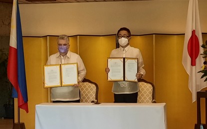 <p><strong>JAPANESE GRANT</strong>. Ambassador Koshikawa (right) and ASHI Chairman of the Board Henry Joseph Herrera present the signed grant contract for the procurement of delivery trucks for small farmers in Laguna, Rizal, and Antique. The Japanese envoy signed four contracts on Thursday (March 3, 2022) at his residence in Makati. <em>(Photo by Joyce Rocamora)</em></p>