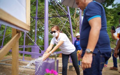 <p><strong>WATER SYSTEM.</strong> North Governor Nancy Catamco (center) tries potable water flowing out from the pipe of a P1.5 million water system inaugurated on Monday (Feb. 28, 2022) in Barangay Nabundasan, Tulunan town of the province. The village, a former New People’s Army-infested area, is a beneficiary of projects under the government’s whole of nation approach to end the local communist conflict in the countryside. <em>(Photo courtesy of North Cotabato PIO)</em></p>