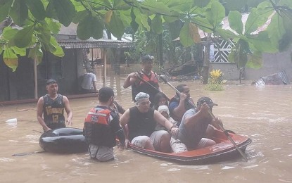 <p><strong>FLOOD RESCUE.</strong> Iligan City's rescuers from the Disaster Risk Management Office on Monday (March 7, 2022) carry residents in boats when their houses were flooded in Zone Caugmaran, Barangay Suarez. Heavy rains brought about by the low pressure area on Sunday have caused several areas in the city to be flooded. <em>(Photo courtesy of Iligan-DRRMC)</em></p>