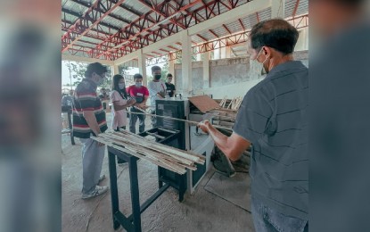 <p><strong>ENGINEERED BAMBOO</strong>. Bamboo craters and planters try the state-of-the-art equipment at the Bamboo Center in the University of Antique Main Campus in Sibalom, Antique on February 24, 2022. Dr. Nelly Mistio, UA Project Component Leader, said during a virtual press conference Monday that they are encouraging bamboo farmers to plant more to be used as raw materials.<em> (Photo courtesy of UA Main Campus)</em></p>