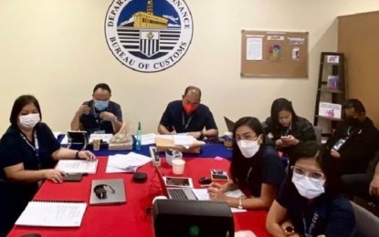 <p><strong>ISO CERTIFICATION</strong>. Bureau of Customs-Subport of Mactan collector Gerardo Campo (second from left) is seen in this Feb. 21, 2022 photo leading customs officers in presenting the documents to the German auditing firm, TüvSüd. BOC-Cebu maintained its ISO 9001:2015 certification after the independent auditors gave them passing mark, which means its customs clearance processing system and payment of customs duties and taxes, among others, are way within the international standards. <em>(Photo courtesy of BOC-Mactan)</em></p>