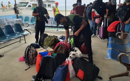 <p><strong>INTERDICTION OPERATIONS.</strong> Personnel from the Philippine Drug Enforcement Agency (PDEA-7) conducts a random K-9 inspection of passenger bags and luggage at the local pier in Siquijor port in this undated photo. PDEA Director General Moro Virgilio Lazo on Monday (Sept. 16, 2024) said they are poised to start its own Narcotics Detection Dog Breeding Program (NDDBP) to enable the agency to breed and train its own K-9 units. <em>(Photo courtesy of PDEA-7)</em></p>