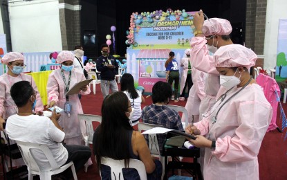 <p><strong>4TH VAX DRIVE.</strong> Health workers check the condition of the vaccinees before administering Covid-19 jabs at the start of the 4th National Vaccination drive at the Ugnayang La Salle gymnasium in Dasmariñas City, Cavite on Thursday (March 10, 2022). The government aims to administer 1.8 million doses during the "Bayanihan, Bakunahan'' from March 10 to 12. <em>(PNA photo by Gil Calinga)</em></p>