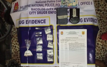 <p><strong>EVIDENCE</strong>. Operatives of the Bacolod City Police Office City Drug Enforcement Unit recover PHP550,800 worth of suspected shabu during a buy-bust in Barangay Tangub on Friday night (March 11, 2022). The arrested suspect, Joebert “Kulot” Carian, 41, has been tagged as a high-value individual. <em>(Photo courtesy of Bacolod City Police Office)</em></p>