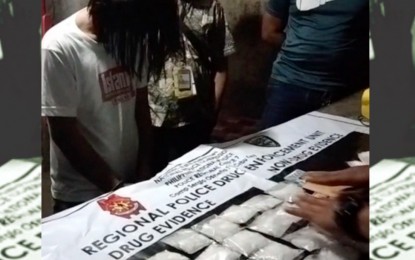<p style="text-align: left;"><strong>DRUG HAUL</strong>. Mark Secretaria Duaban, 42, an alleged "pastor", is in handcuffs as authorities conduct an inventory of some P14.1-million worth of illegal drugs believed to be shabu confiscated from him in a buy-bust operation in Cebu City on Wednesday night (March 16, 2022). Regional Drug Enforcement Unit-7 chief Lt. Col. Ronnie Failoga said Duaban is a cousin of Rowen "Yawa" Secretaria, Cebu's third most wanted drug personality who was killed by anti-drug agents in Getafe, Bohol in 2016.<em> (Contributed photo)</em></p>