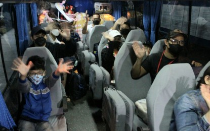 <p><strong>HOMEBOUND.</strong> Three families composed of 12 individuals are on the bus bound for Zambales province as they leave Metro Manila for good on Friday (March 18, 2022). They are beneficiaries of the "Balik Probinsya, Bagong Pag-asa" program that aims to decongest the National Capital Region while helping hard-up families restart their lives with financial and livelihood assistance. <em>(PNA photo by Robert Oswald P. Alfiler)</em></p>
