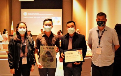 <p><strong>GOLDEN EFFORTS.</strong> Davao Oriental Provincial Anti-Drug Abuse Council action officer, Ronald Vidoy (2nd from left), receives the province’s Gold Award at the Davao Region Anti-Drug Abuse Council Performance Awards at the Acacia Hotel in Davao City on March 15, 2022. Seven local government units in the Davao Region also received recognition for their exemplary efforts to fight illegal drugs and reform former users and dealers. <em>(Photo courtesy of Provincial Government of Davao Oriental Facebook)</em></p>