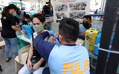 <p><strong>BOOSTED.</strong> Medical staff of the Philippine National Police join the 4th National Vaccination Days at Plaza Miranda in Manila on March 11, 2022. As of March 22, the government has already fully vaccinated 65,171,415. <em>(PNA photo by Joey O. Razon)</em></p>