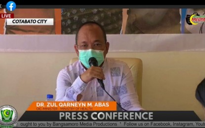 <p><strong>FEWER COVID-19 CASES.</strong> Dr. Zul Qarneyn Abas, acting head of the Ministry of Health–Bangsamoro Autonomous Region in Muslim Mindanao, speaks during a regular news conference Tuesday (March 22, 2022). BARMM, which has only 18 active coronavirus disease 2019 cases to date, is working double time on its immunization drive to downgrade its current Alert Level 2 status.<em> (Photo courtesy of MOH-BARMM)</em></p>