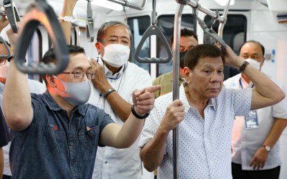 <p><strong>MRT-3 FREE RIDES.</strong> President Rodrigo Roa Duterte (right at foreground) inspects the train as he rides from Shaw Boulevard Station to Santolan Station following the completion ceremony of the Metro Rail Transit Line-3 (MRT-3) rehabilitation project at the Shaw Boulevard Station in Mandaluyong City on March 22, 2022. For the past 10 weekdays, the MRT-3 logged over 350,000 daily passengers, culminating in another record-high 370,713 passengers served on Wednesday (June 8, 2022). <em>(Presidential photo by Ace Morandante)</em></p>