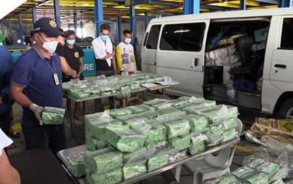 <p><strong>DRUG HAUL.</strong> Agents of the National Bureau of Investigation Task Force Against Illegal Drugs inspect the PHP11 billion worth of shabu seized from 10 suspects in three vehicles in Infanta, Quezon on March 15, 2022. The Department of Justice has recommended the filing of charges against the 10. <em>(Photo courtesy of NBI)</em></p>