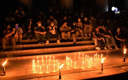 <p><strong>EARTH HOUR.</strong> Representatives of various youth organizations in Negros Occidental join the observance of Earth Hour 2022 at the Provincial Capitol grounds in Bacolod City on Saturday night (March 26, 2022). Initiated by the Provincial Environment Management Office, the event was highlighted by the lighting of candles formed into the 60+ symbol and the switch-off of lights from 8:30 p.m. to 9:30 p.m. <em>(Photo courtesy of PIO Negros Occidental)</em></p>