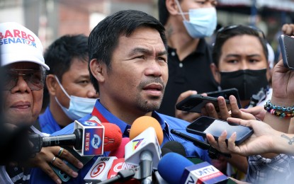 <p><strong>PACQUIAO IN QC</strong>. Senator Manny Pacquiao answers newsmen's questions at a stop during his campaign in Barangay Tatalon, Quezon City on Tuesday (March 29, 2022). Pacquiao said he hopes for a peaceful resolution to the WPS issue. <em>(PNA photo by Joey Razon)</em> </p>