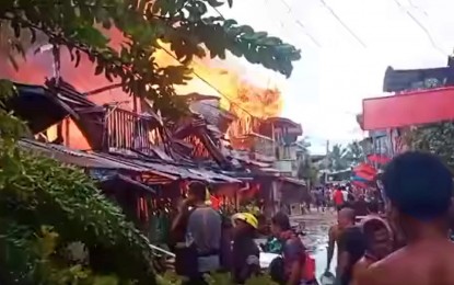 <p><strong>HUGE FIRE.</strong> Residents try to save their valuables during a fire that hit a residential area in Cotabato City on Monday (March 28, 2022). Damage to properties was pegged at PHP500,000. <em>(Photo courtesy of Alim Sander)</em></p>