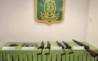 <p><strong>SEIZED NPA FIREARMS.</strong> The Army’s 23rd Infantry Battalion present the four AK-47 rifles, one M1 Garand rifle, four AK-47 magazines, and ammunition they recovered from the communist New People’s Army rebels at Sitio Mahogany, Barangay Ibuan in Las Nieves town, Agusan del Norte on Monday (March 28, 2022). A female NPA surrenderer wounded during the series of gun battles in the area pinpointed the location of the arms cache. <em>(Photo courtesy of 23IB)</em></p>