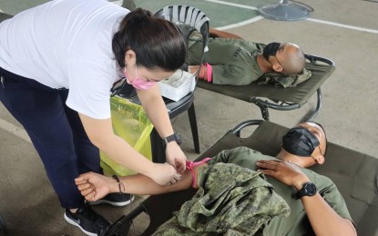 <p><strong>BLOOD DONATION.</strong> A Philippine Army soldier under the 7th Infantry Division donates blood during the bloodletting activity dubbed ‘Dugong Alay ng Kaugnay, Dugtong ng Inyong Buhay’ at Fort Magsaysay, Palayan City, Nueva Ecija on Tuesday (March 29, 2022). The activity aimed to strengthen ties and partnerships with various stakeholders in support of the initiatives of the 7ID Transformation Roadmap (ATR).<em> (Photo courtesy of 7ID, PA)</em></p>
