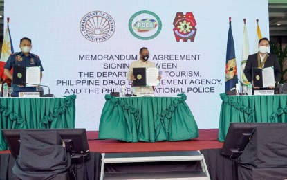<p><strong>TOURISM PARTNERSHIP</strong>. (L-R) PNP Chief, Gen. Dionardo B. Carlos; PDEA Director General, Undersecretary Wilkins M. Villanueva; and DOT Undersecretary Woodrow Maquiling Jr., during the ceremonial signing of the memorandum of agreement in Quezon City on March 14, 2022. The partnership seeks to ensure further protection, safety, and security of tourists in DOT-identified destinations. <em>(Photo by DOT)</em></p>