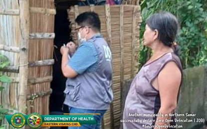 <p><strong>SANITATION CHECK</strong>. A staff of the Department of Health checks a makeshift toilet in Bobon, Northern Samar during a validation activity in this undated photo. The Department of Health (DOH) confirmed on Thursday (March 30, 2022) that the town achieved a zero open defecation status.<em> (Photo courtesy of DOH Eastern Visayas)</em></p>