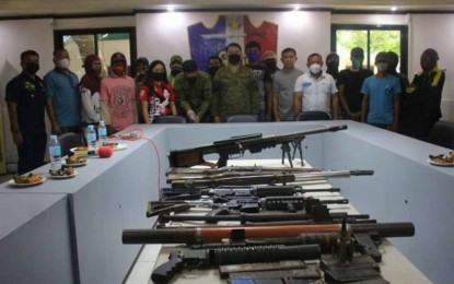 <p><strong>WEARY COMBATANTS.</strong> Moro extremists who yield to the Army pose with government security forces in Maguindanao after turning over high-powered firearms during surrender rites in Datu Saudi Ampatuan town on Wednesday (March 30, 2022). The surrenderers, all members of the Bangsamoro Islamic Freedom Fighters– Karialan faction, say they are all tired of the relentless military operations against them. <em>(Photo courtesy of 40IB)</em></p>