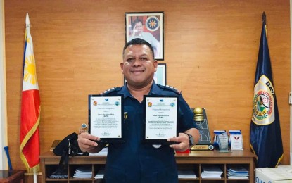 <p><strong>MAJOR AWARDS.</strong> Col. Alberto Lupaz, acting director of the Davao City Police Office, shows the two plaques won by their unit during the 2022 National Women’s Month culmination awarding ceremony held at the Police Regional Office in Davao Region Monday (April 4, 2022). The awards are ‘Best Women and Children’s Protection Desk (WCPD) Unit for City Police Office/Police Provincial Office category regionwide, and first runner-up in the ‘Investigator’s Olympics tilt.<em> (Photo courtesy of DCPO)</em></p>