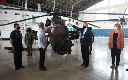 <p><strong>NEW AIR ASSETS.</strong> Secretary Delfin Lorenzana with the Ambassador of the Republic of Turkey Dr. Ismail Demir during the ceremonial pouring of champagne to one of the T129 "ATAK" helicopters at the 250th Presidential Air Wing Hangar, Villamor Air Base, Pasay City on Wednesday (April 6, 2022). The Philippine Air Force formally accepted two brand-new "ATAK" helicopters and one Airbus Defense and Space C-295 medium lift aircraft. <em>(PAF photo)</em></p>