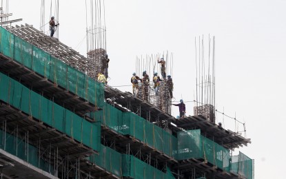 <p><strong>HIGH RISE.</strong> Workers are busy constructing a high-rise building on Scout Gandia in Quezon City on Nov. 6, 2020. The wholesale and retail price index of construction materials in the National Capital Region eased in April compared to the previous month. <em>(PNA photo by Joey O. Razon)</em></p>