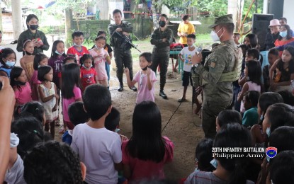 <p><strong>OUTREACH</strong>. Soldiers spend time with children during a book launch in this Dec. 1, 2021 photo. The Philippine Army in Northern Samar is largely counting on the support of locals to win the war against the New People’s Army in the province.<em> (Photo courtesy of Philippine Army's 20th Infantry Battalion)</em></p>