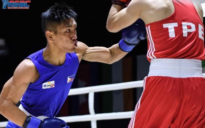 <p><strong>FINALS HOPEFUL</strong>. Rogen Ladon (left) unleashes a left hook against Po-Wei Tu of Chinese Taipei in their flyweight quarterfinal match in the Thailand Open International Boxing Tournament at the Angsana Laguna Phuket Resort Hotel in Thailand on Wednesday (April 6, 2022). Ladon easily won, 5-0, to secure at least a bronze medal and advance to the semis. <em>(Photo courtesy of Thailand Boxing Association)</em></p>
