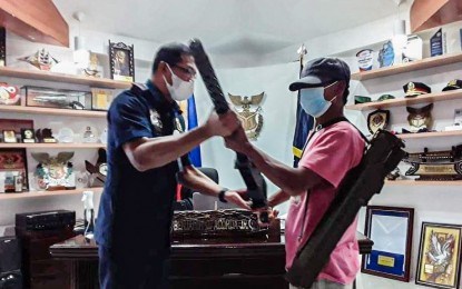 <p><strong>NEW SURRENDER</strong>. A New People's Army platoon commanding officer surrenders and turns over two high-powered firearms to Police Region Office 10 at regional headquarters, Camp 1Lt Vicente G Alagar, Lapasan village, Cagayan de Oro City on April 6, 2023. Senator JV Ejercito said on Thursday (Dec. 7, 2023) that the rebels should give up their arms to show commitment to the peace talks with the national government. <em>(Photo courtesy of PRO-10) </em></p>