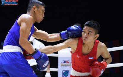<p><strong>GOLD MEDAL ROUND.</strong> Rogen Ladon (left) throws a left hook even as he tries to evade Thanarat Saengphet of Thailand during their flyweight semifinals bout in the Thailand Open International Boxing Tournament at the Angsana Laguna Phuket Resort Hotel on Friday (April 8, 2022). Ladon won, 4-1, to reach the gold medal round on Saturday. <em>(Contributed photo)</em></p>