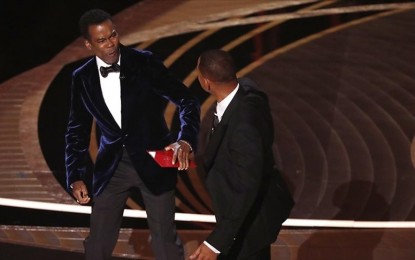 <p><strong>ON TARGET.</strong> Will Smith (right) smacks fellow actor Chris Rock onstage at the Academy Awards held at Dolby Theatre in Los Angeles, California on March 27, 2022. Smith did not like the joke the comedian made in reference to his wife’s hair-loss condition but his action earned him a 10-year ban from attending the event also popularly known as the Oscars. <em>(Anadolu)</em></p>