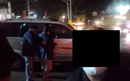 <p><strong>ARRESTED.</strong> Anakpawis party-list-Cagayan Valley coordinator and fourth nominee Isabelo Adviento (right) is led into a waiting vehicle after his arrest at a fast-food restaurant in Barangay Luyang, Bayombong, Nueva Vizcaya on Friday night (April 8, 2022). Adviento has a standing arrest warrant for illegal possession of firearms, ammunition, and explosives. <em>(PNP-Bayombong photo)</em></p>