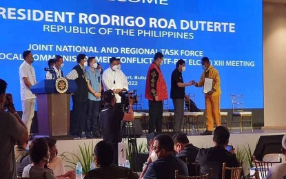 <p><strong>ANCESTRAL DOMAIN.</strong> President Rodrigo R. Duterte (2nd from right) hands over to Datu Randy Catarman (right) a Certificate of Ancestral Domain Title for his tribe covering the areas of Jabonga and Nasipit in Agusan del Norte on Tuesday (April 12, 2022) in Butuan City. The President visited Butuan to meet with the members of the National Task Force to End Local Communist Armed Conflict and the proclamation rally of the PDP-LABAN in Buenavista, Agusan del Norte. <em>(Photo courtesy of PIA-Caraga)</em></p>