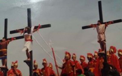 <p><strong>ANNUAL RITUAL</strong>. Filipino penitent Ruben Enaje (center) and two others nail on the cross on Good Friday in this undated photo. Enaje said his annual devotion has been disrupted for the third straight time due Covid-19 but promised to resume ritual by next year after the pandemic. <em>(Contributed photo)</em></p>