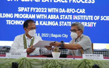 <p><strong>INTERVENTIONS FOR CBA-CPLA.</strong> Presidential Adviser on Peace, Reconciliation and Unit Secretary Carlito Galvez Jr. (left) and Department of Agriculture-Regional Field Office-Cordillera Administrative Region Director Dr. Cameron Odsey sign memorandum of agreements on April 8, 2022. The agreements were signed for the implementation of the second phase of the Sustainable and Inclusive Peace and Transformation (SIPAT) Program for the former Cordillera Bodong Administration – Cordillera People's Liberation Army (CBA-CPLA) combatants. <em>(Photo courtesy of OPAPRU)</em></p>