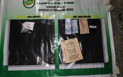 <p><strong>DRUG BUST.</strong> Authorities present the suspected shabu and marked money seized from two female suspects in San Carlos City, Pangasinan past midnight on Saturday (April 16, 2022). The illegal substance weighed around 100 grams and has an estimated value of PHP680,000. <em>(Photo courtesy of PDEA Pangasinan)</em></p>